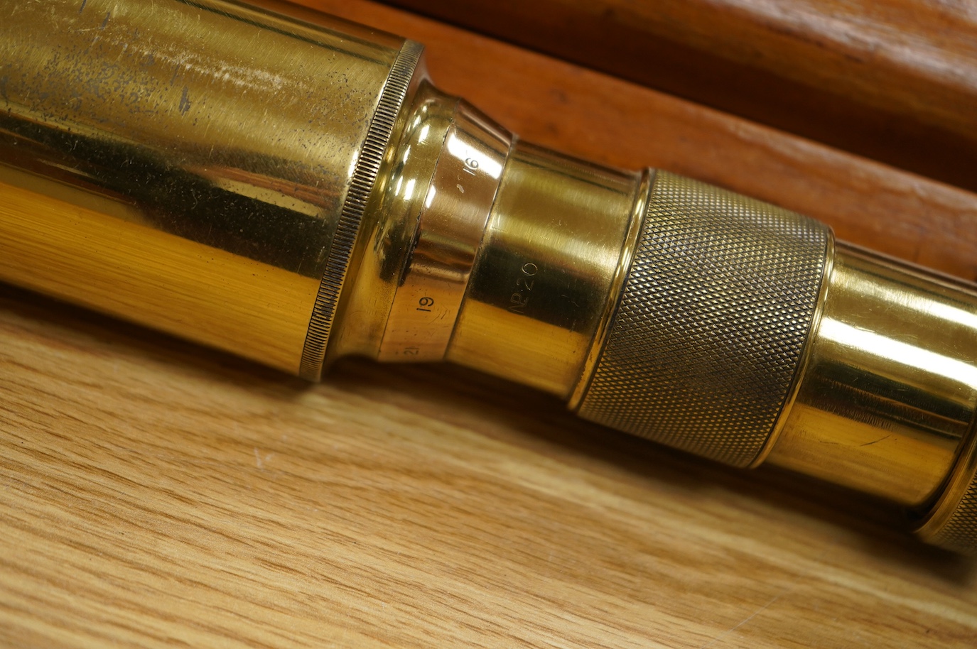 An early 20th century brass telescope with teak tripod by W. Ottway & Co., engraved with; Orion Works Ealing, ‘No.1058, VP 7 to 21 Day & Night Sight Patent 1906’, telescope 65cm long, tripod 160cm. Condition - good.